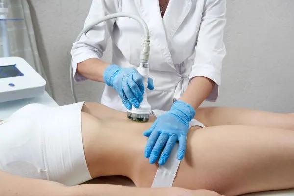 Lost the Weight but Not the Loose Skin? 2 woman having HIFU treatment on her stomach to combat loose skin Sherborne following weight loss
